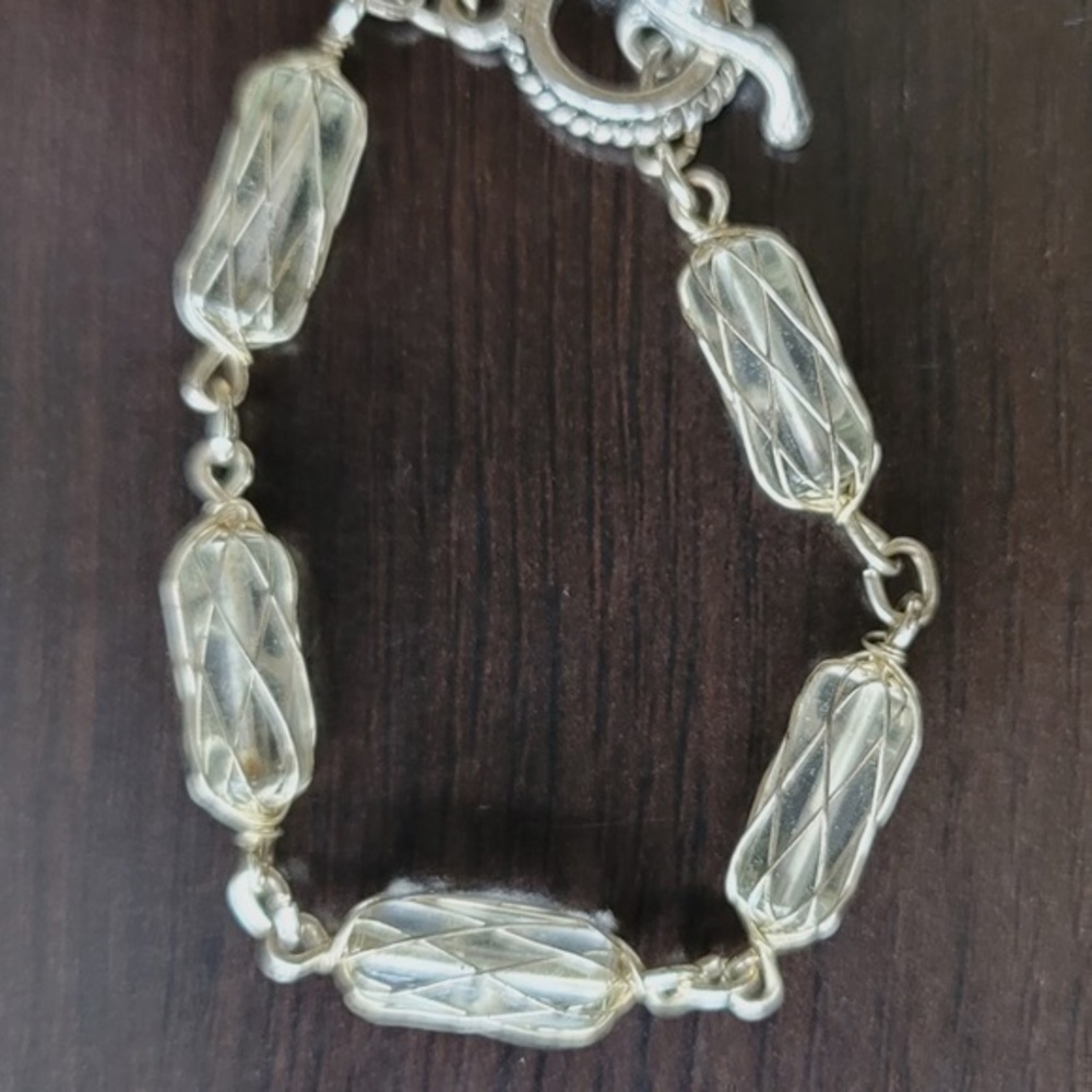 Clear beads wrapped in silver tone wire bracelet